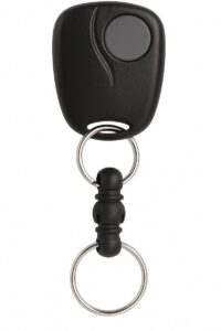 A close-up view of a black Linear single-button remote with a keychain attachment against a white background.
