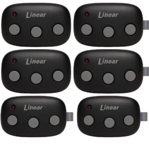 A 2x2 grid of four Linear three-button garage remotes with gray buttons and LED indicators.