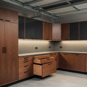 Minimalist new age garage cabinets with black hardware and smooth drawer operation.