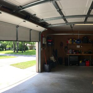 A modern set of garage door hardware components laid out on a clean, white background.