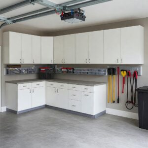 A clean and clutter-free garage achieved with practical wall mounted cabinets.